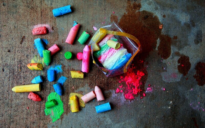 Colorful chalk scattered on ground