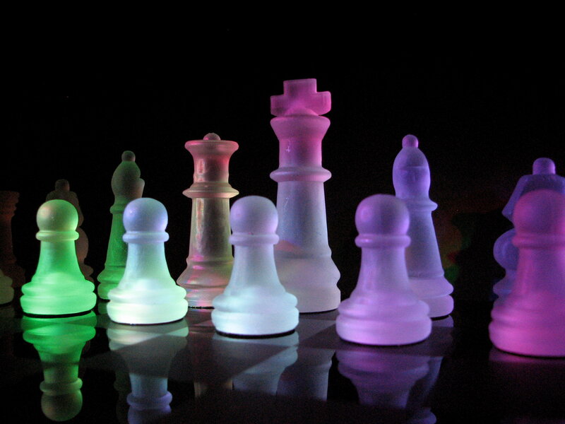 colorful chess pieces on black
