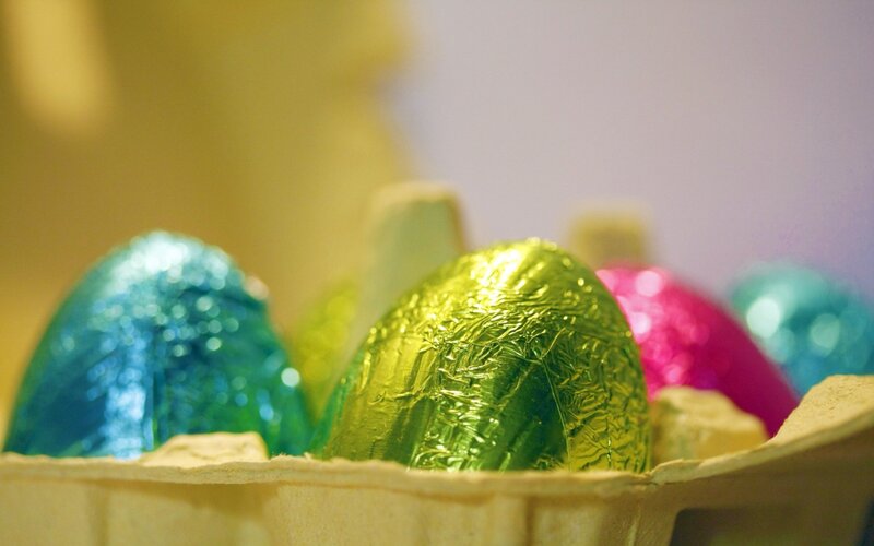 Colorful chocolate eggs in a carton