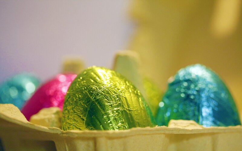 Colorful chocolate eggs in carton