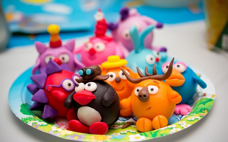 Colorful clay figurines on a plate