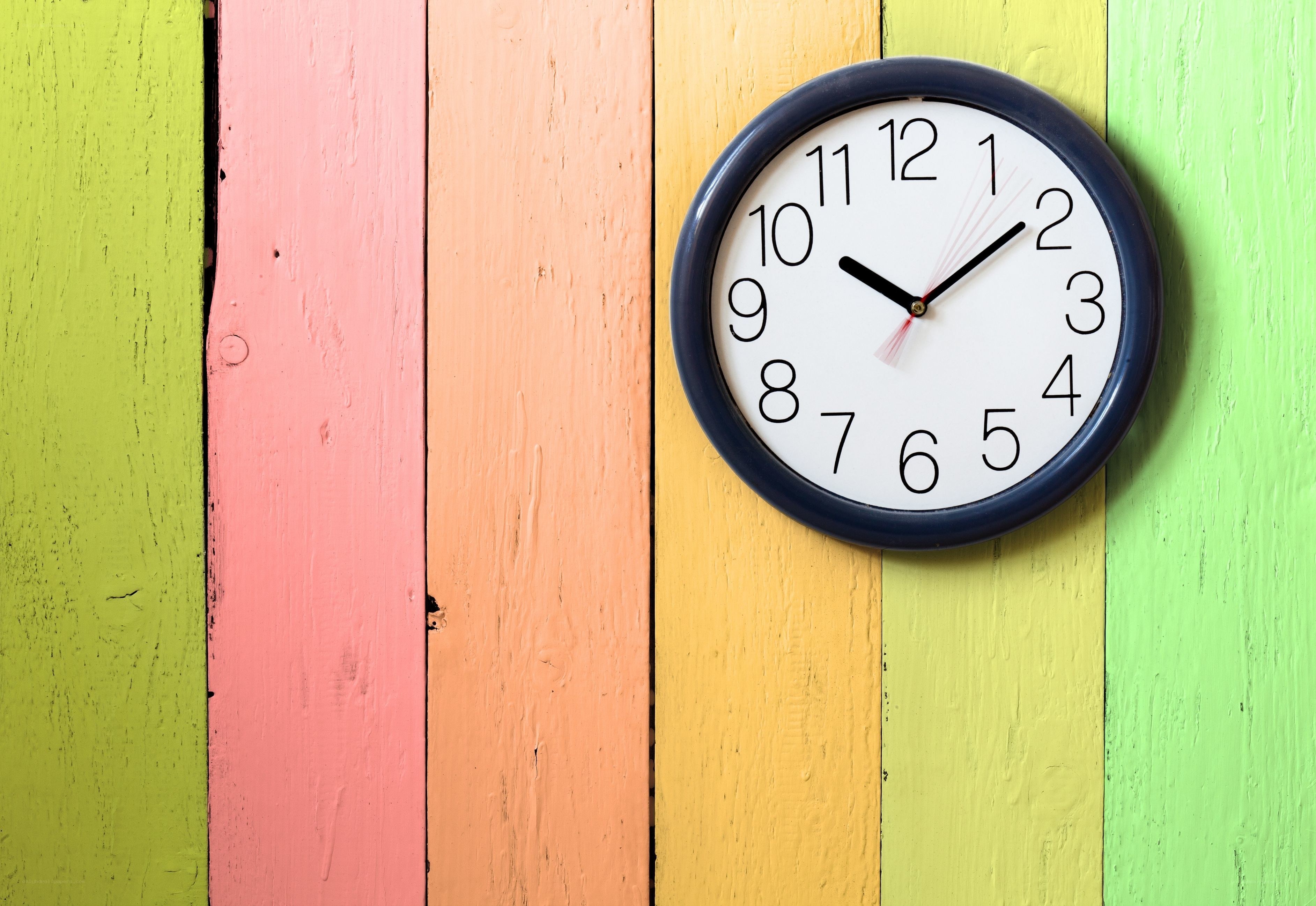 colorful clock on wooden wall