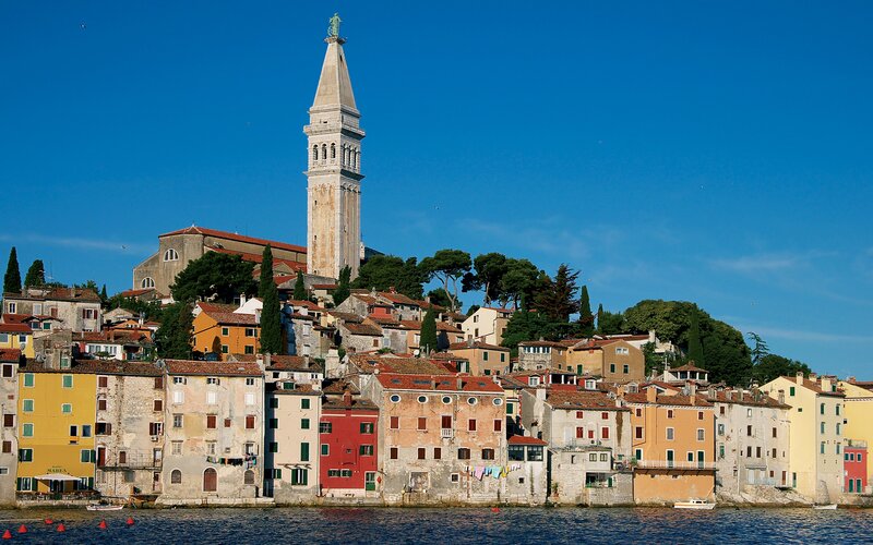 Colorful coastal town with bell tower