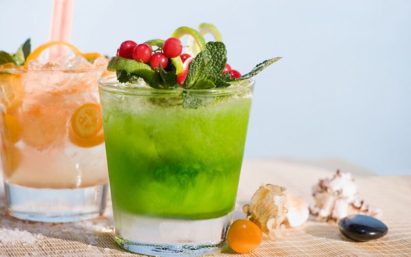 Colorful cocktails with fruit garnish