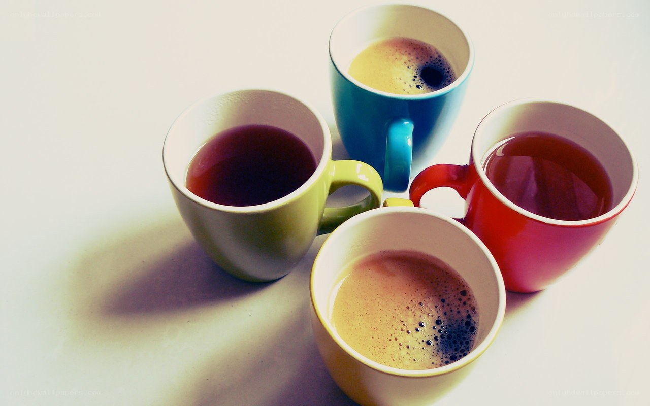 Colorful coffee mugs on white