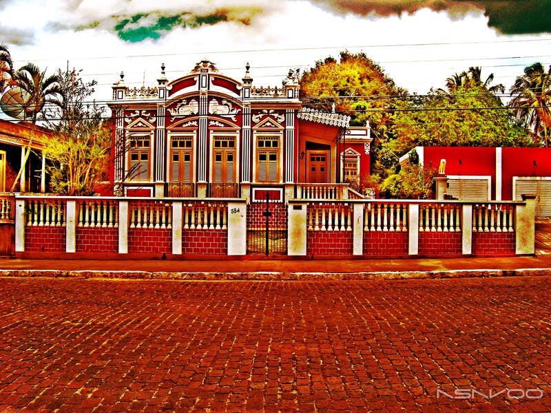 colorful colonial house with red brick street