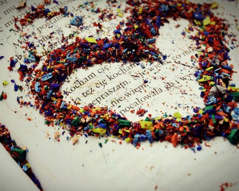 Colorful crayon shavings in a heart