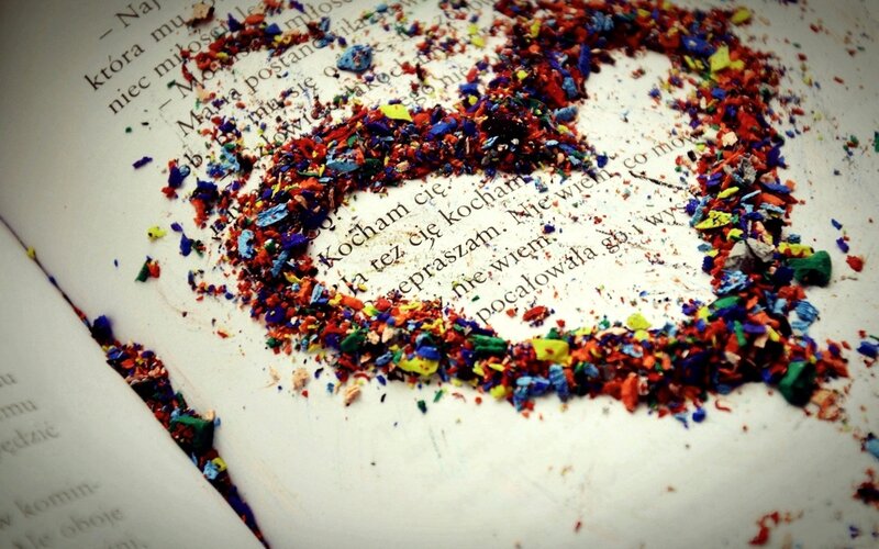Colorful crayon shavings on a book