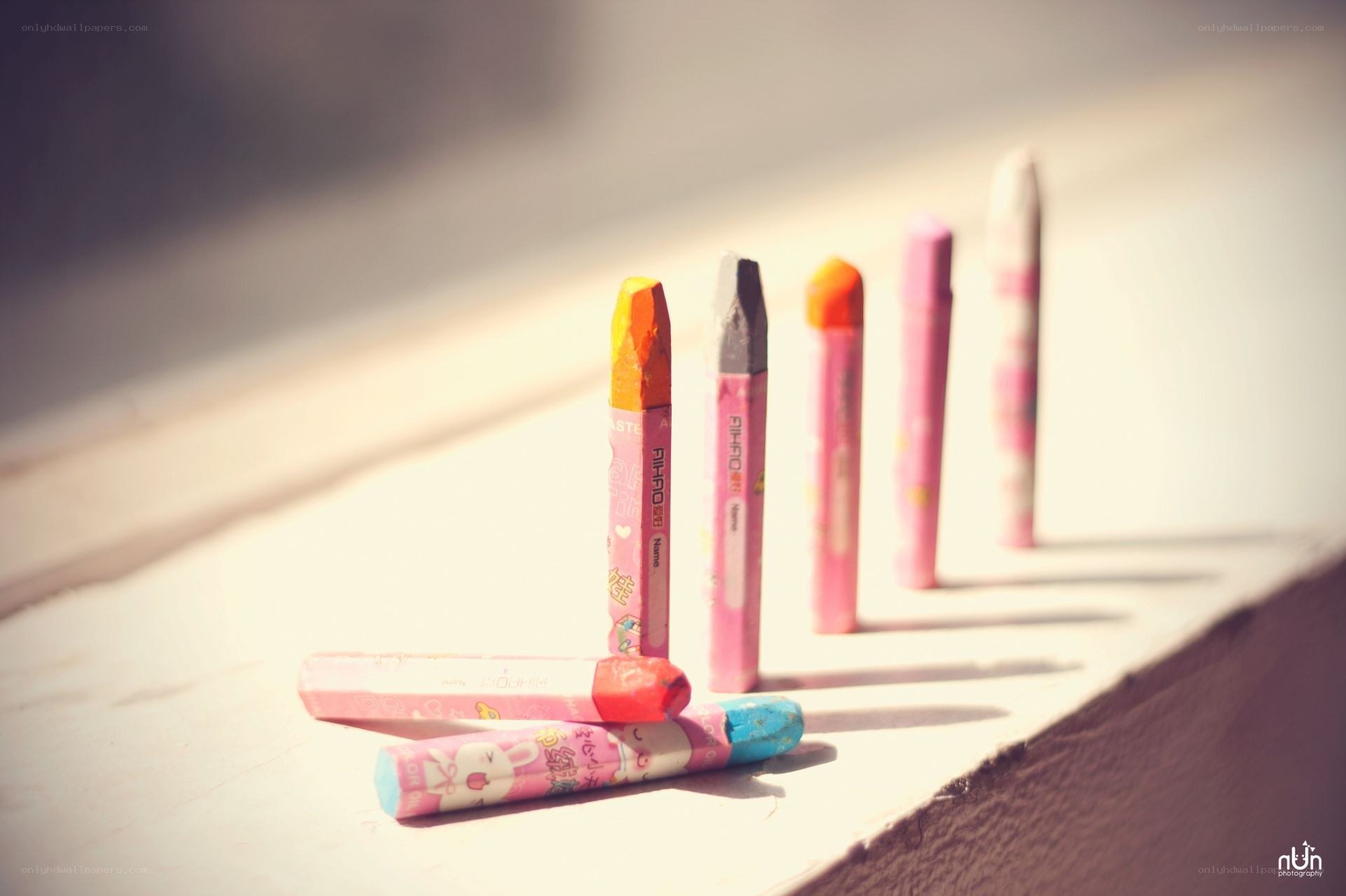 Colorful crayons on a windowsill