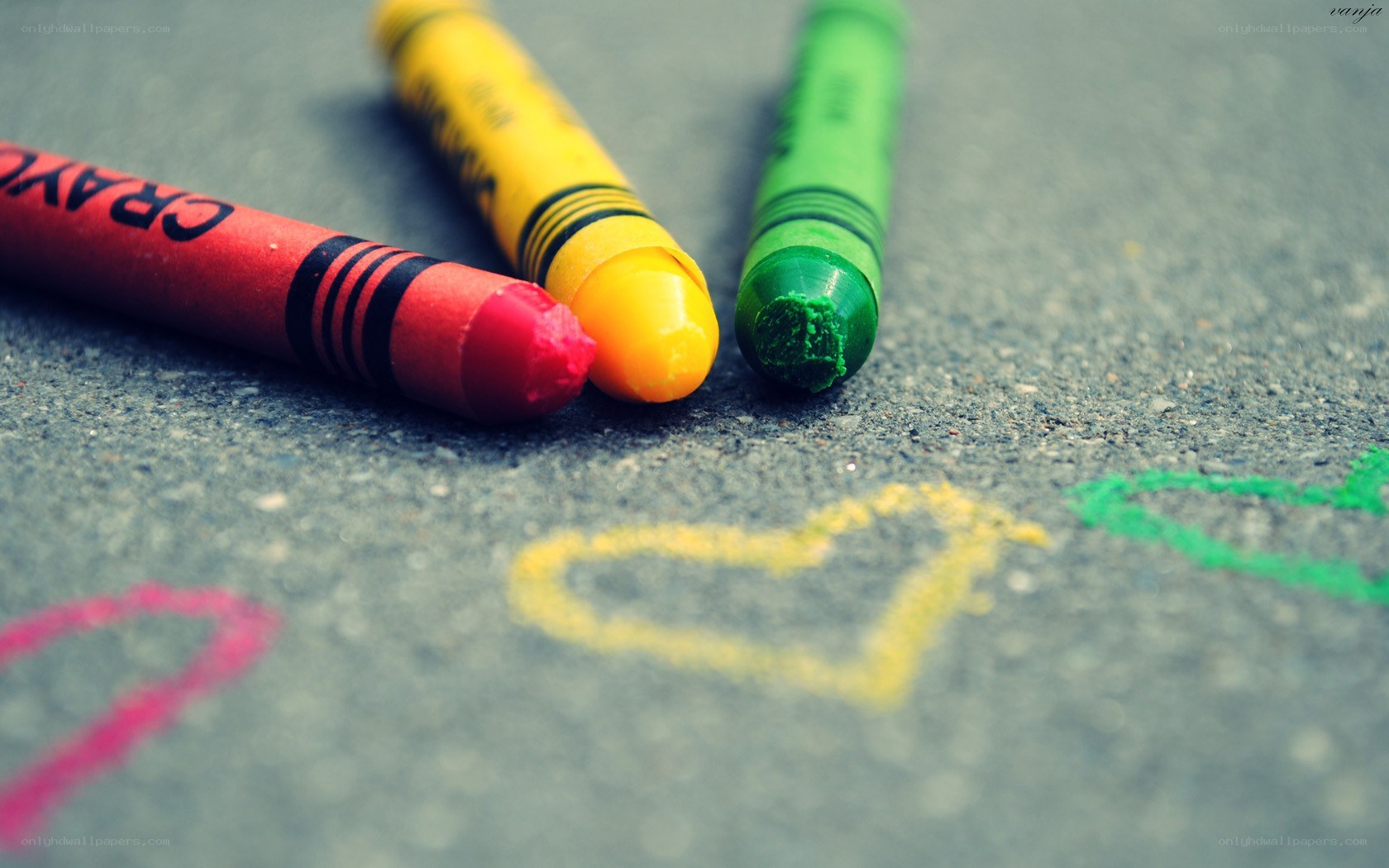 Colorful crayons on pavement