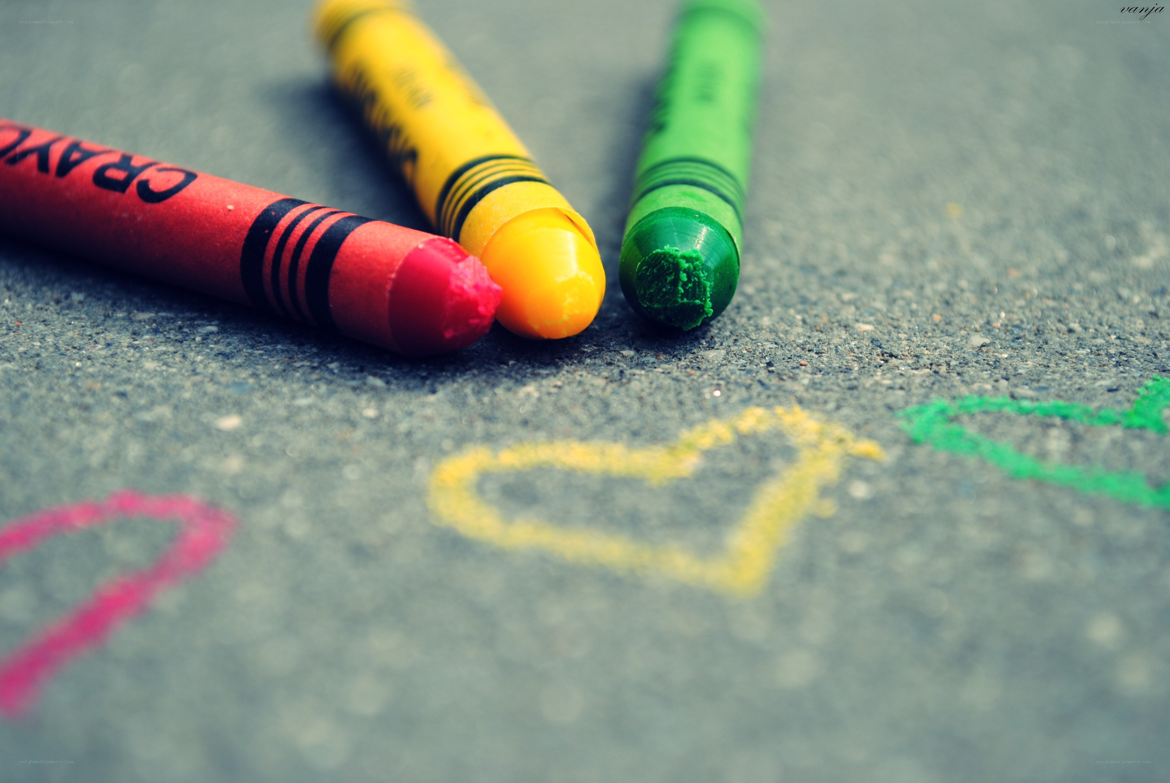 Colorful crayons on pavement