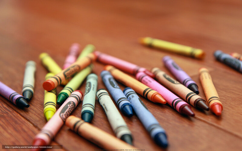 Colorful crayons on wooden surface