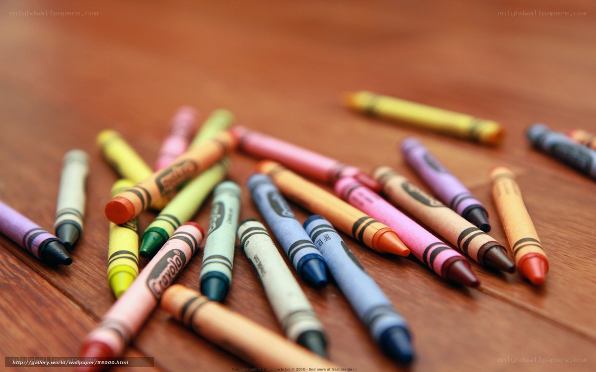 Colorful crayons on wooden surface