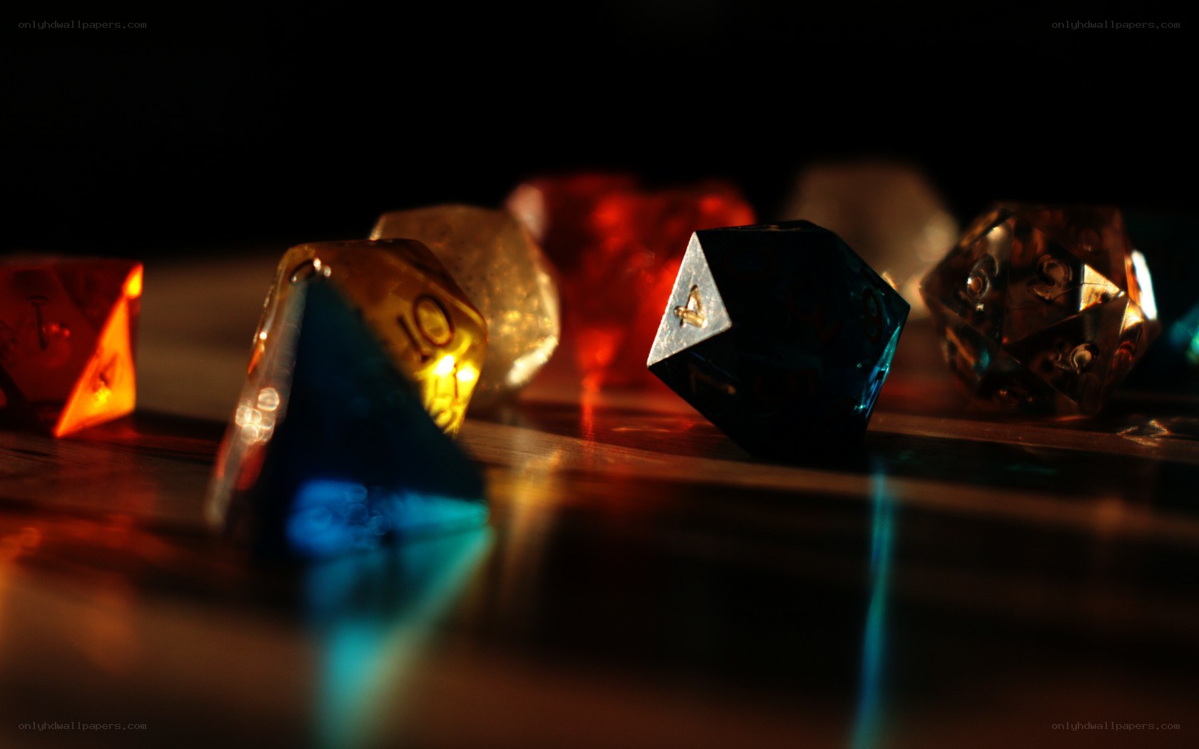 Colorful dice on a dark surface