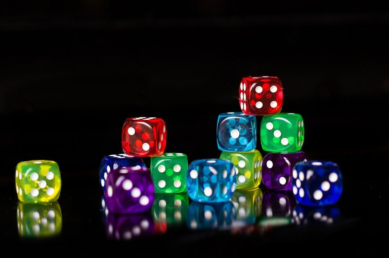 Colorful Dice on Black Surface — Red