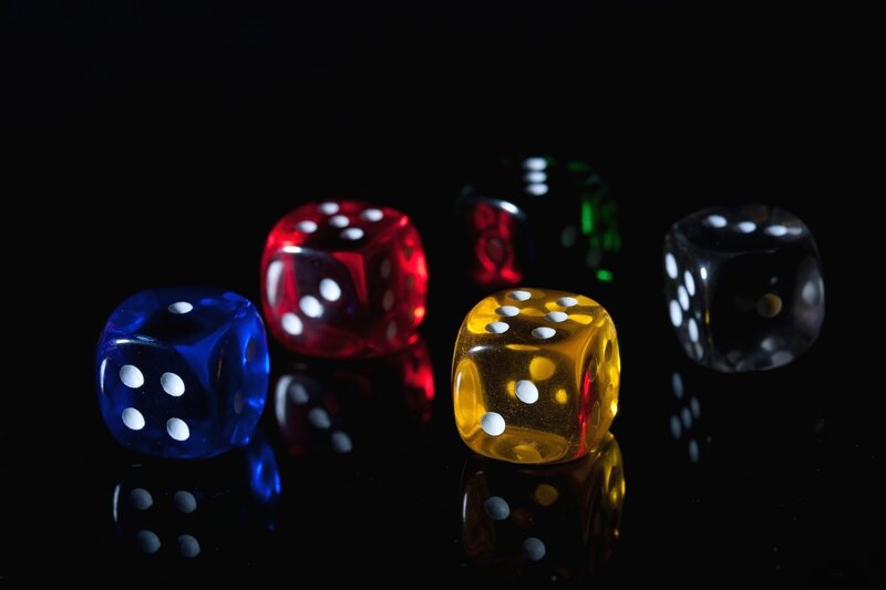 Colorful Dice on Black Surface