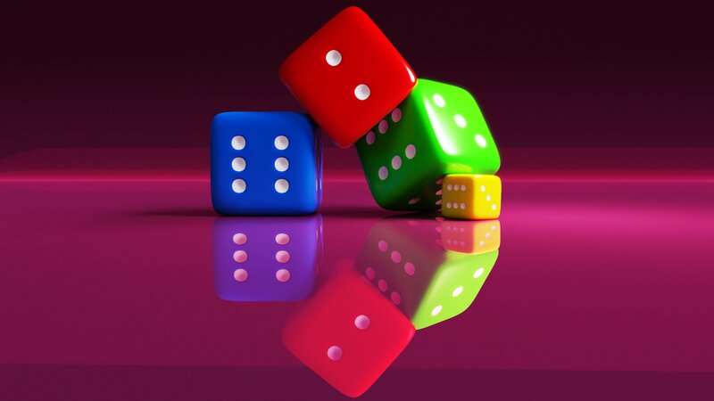 Colorful Dice on Reflective Surface — Red