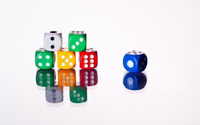 Colorful dice on white surface