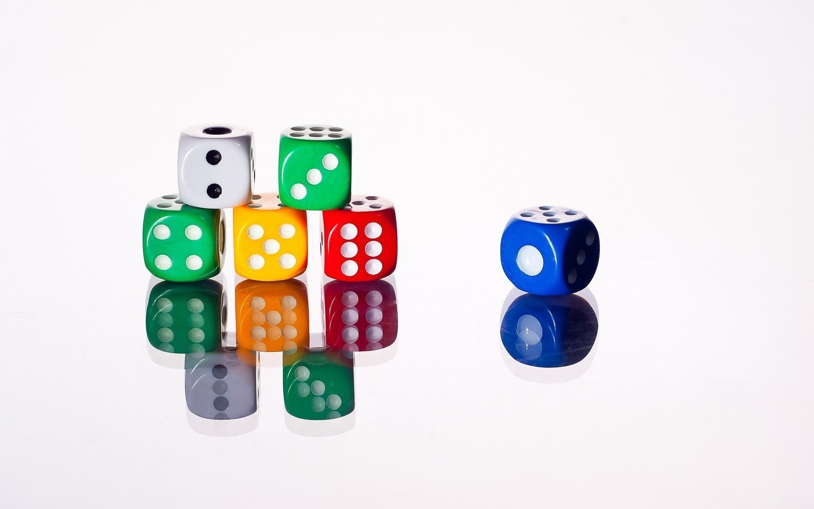 Colorful dice on white surface