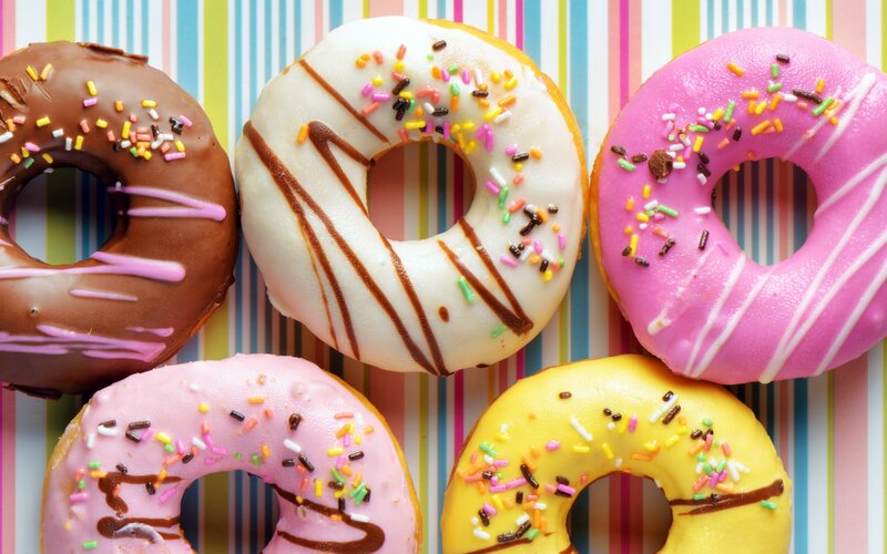 Colorful Donuts on Striped Surface