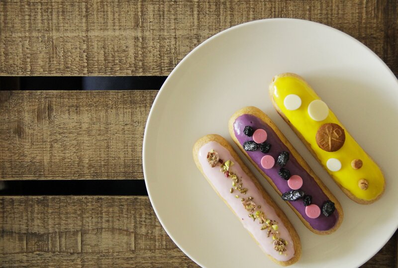 Colorful eclairs on a plate