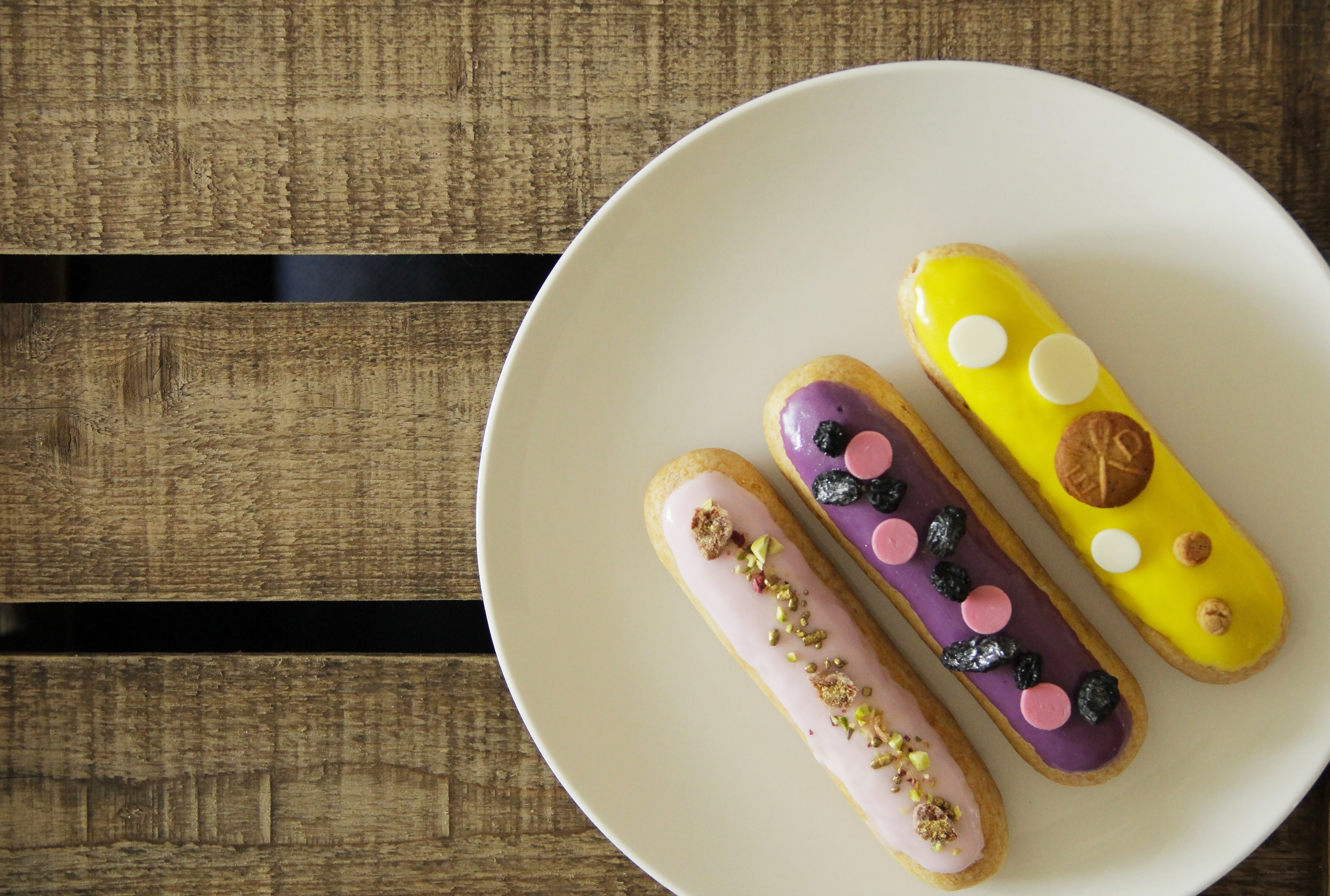 Colorful eclairs on a plate