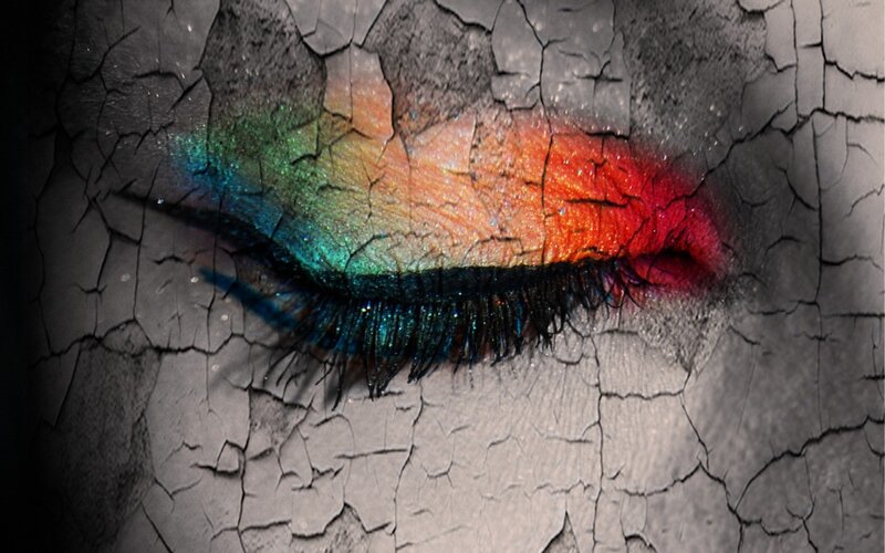 colorful eye makeup on cracked surface