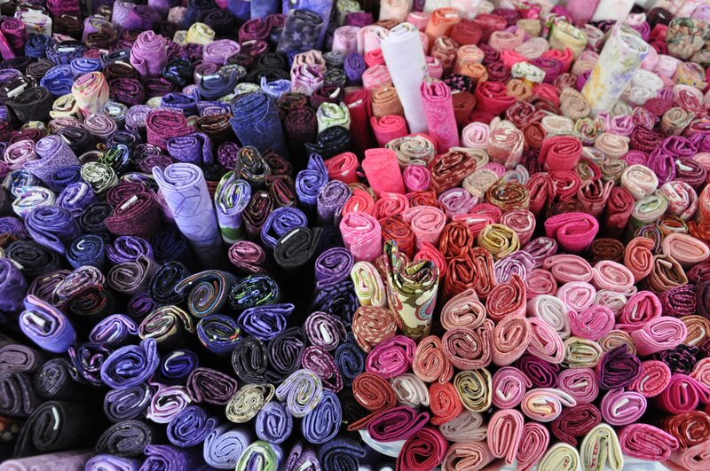 Colorful fabric rolls at market