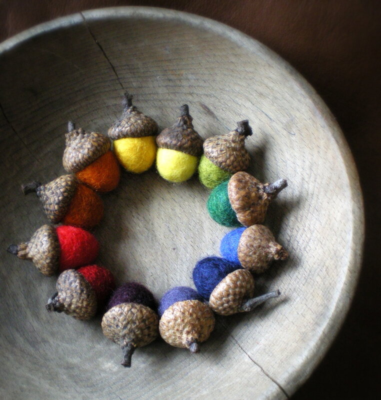 Colorful felt acorns in bowl