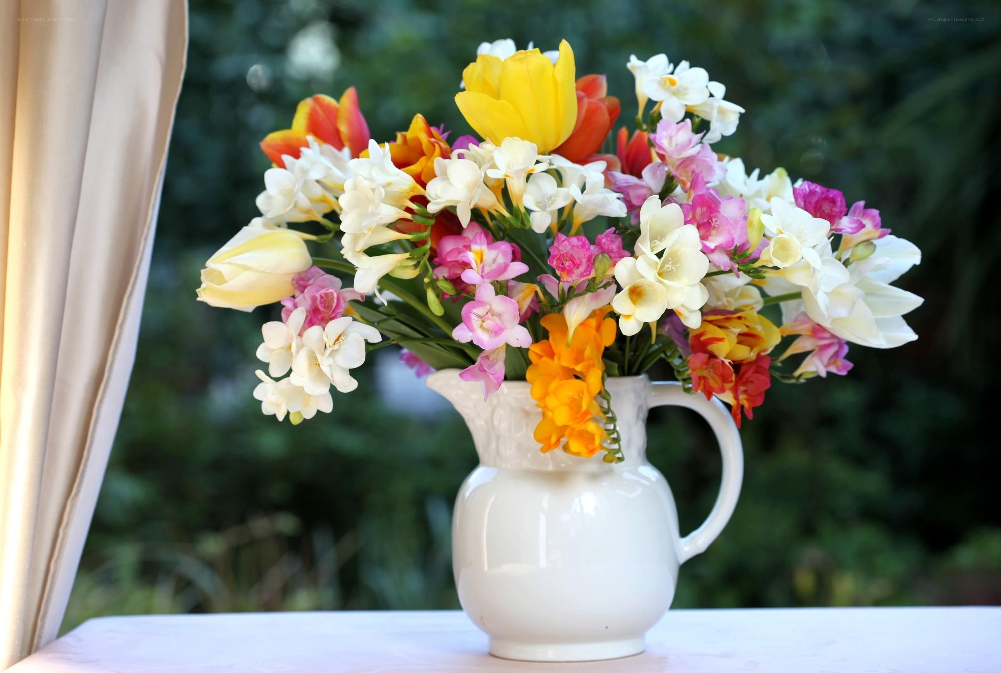 Colorful flower bouquet in a pitcher