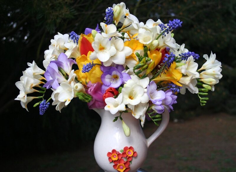Colorful flower bouquet in a pitcher