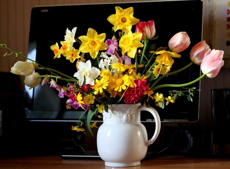 Colorful flower bouquet in a white pitcher