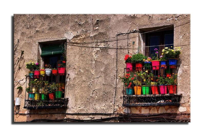 Colorful flower pots on balconies