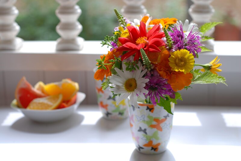 Colorful flowers and fruit bowl