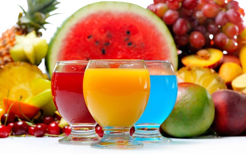 colorful fruit juices with fresh fruits
