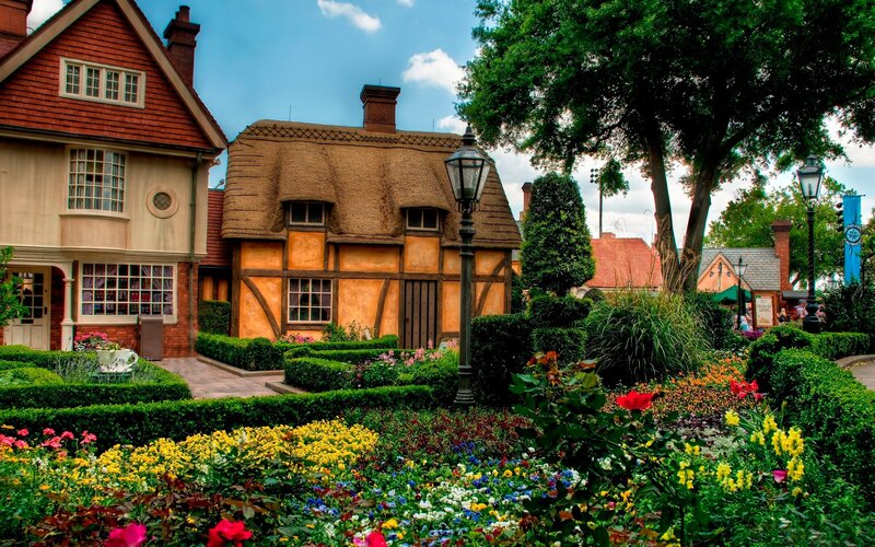 Colorful garden with thatched cottage