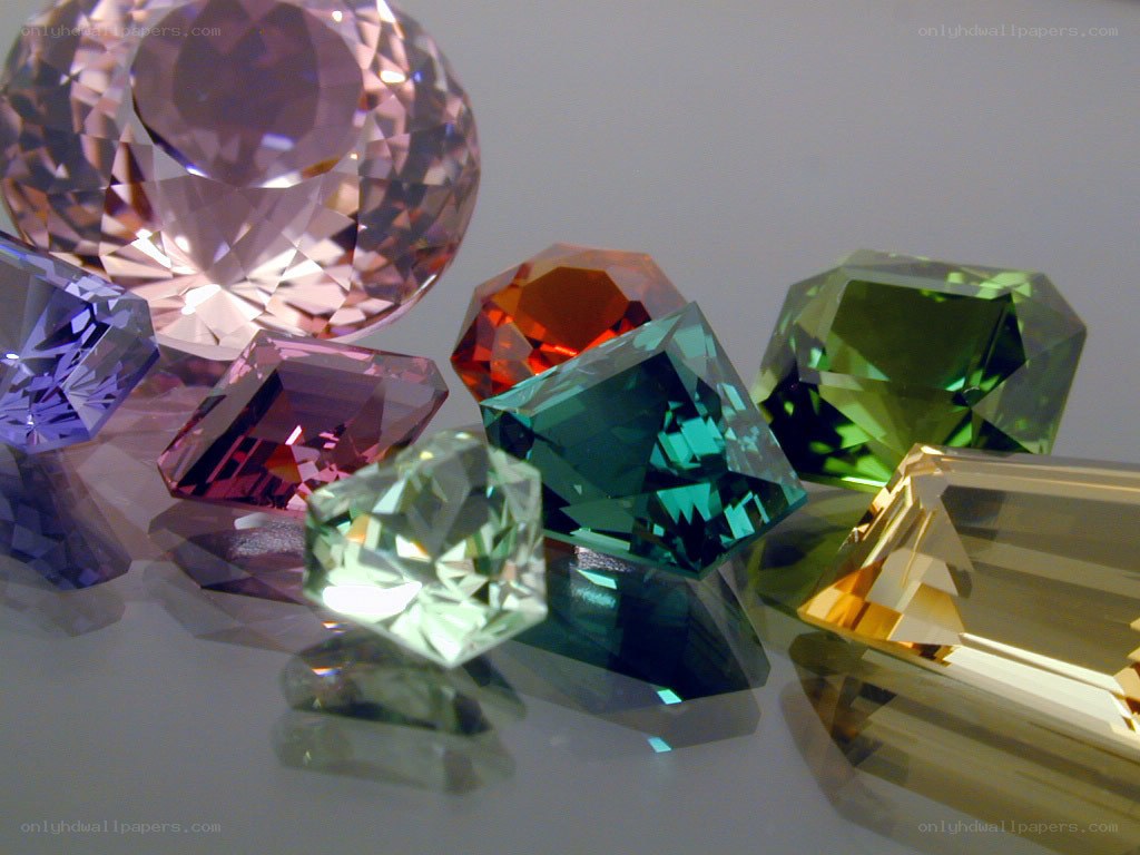 Colorful gemstones on reflective surface