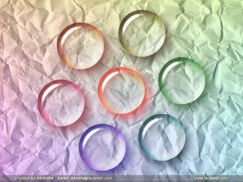 Colorful glass bubbles on crumpled paper