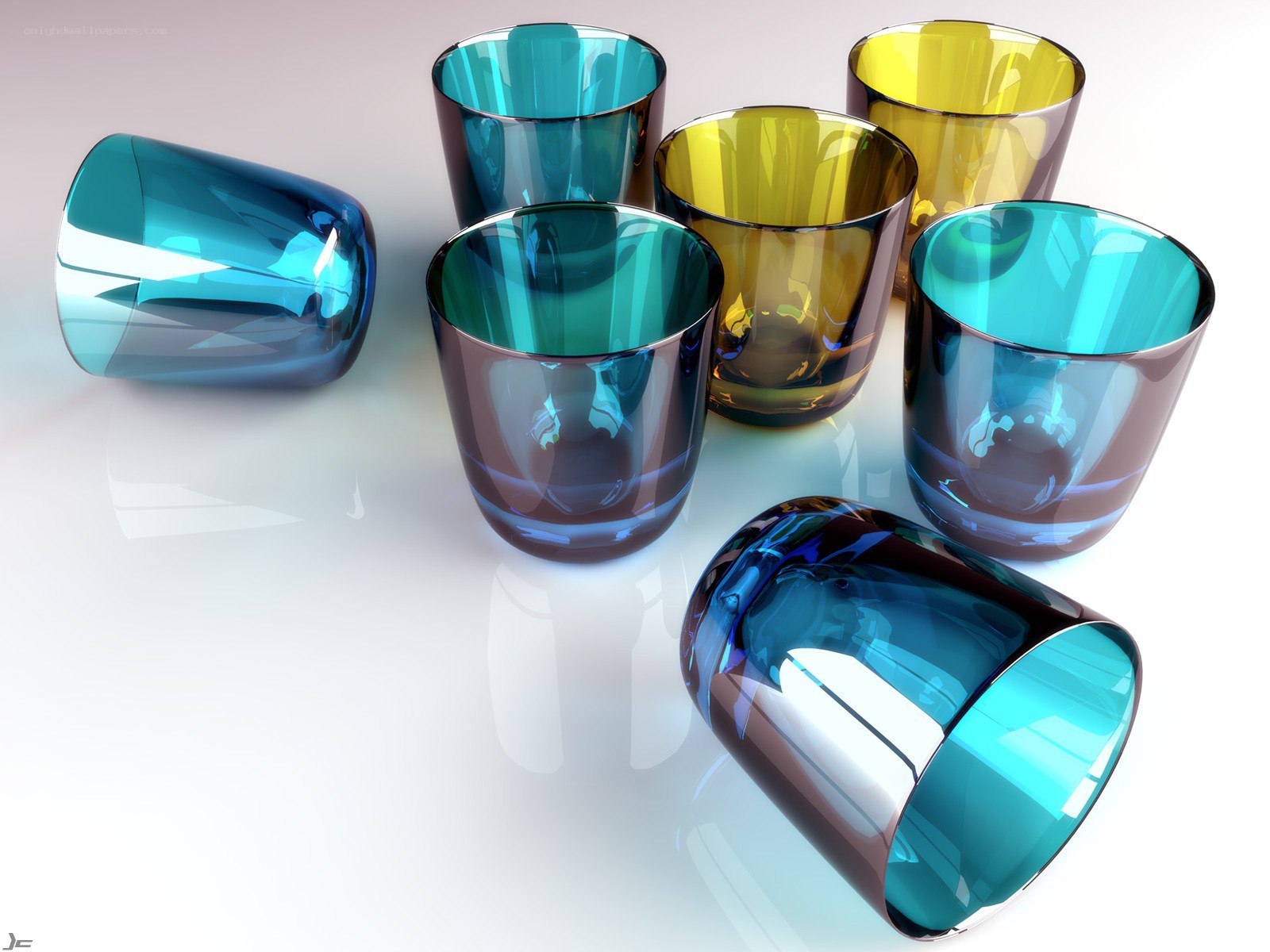 Colorful glass cups on white surface