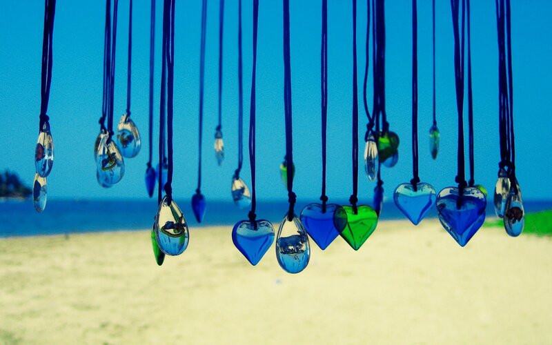 Colorful glass pendants on beach