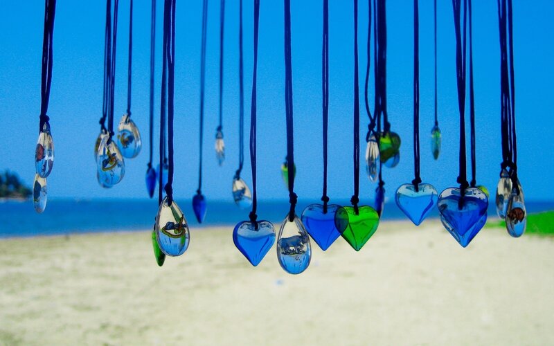 Colorful glass pendants on beach