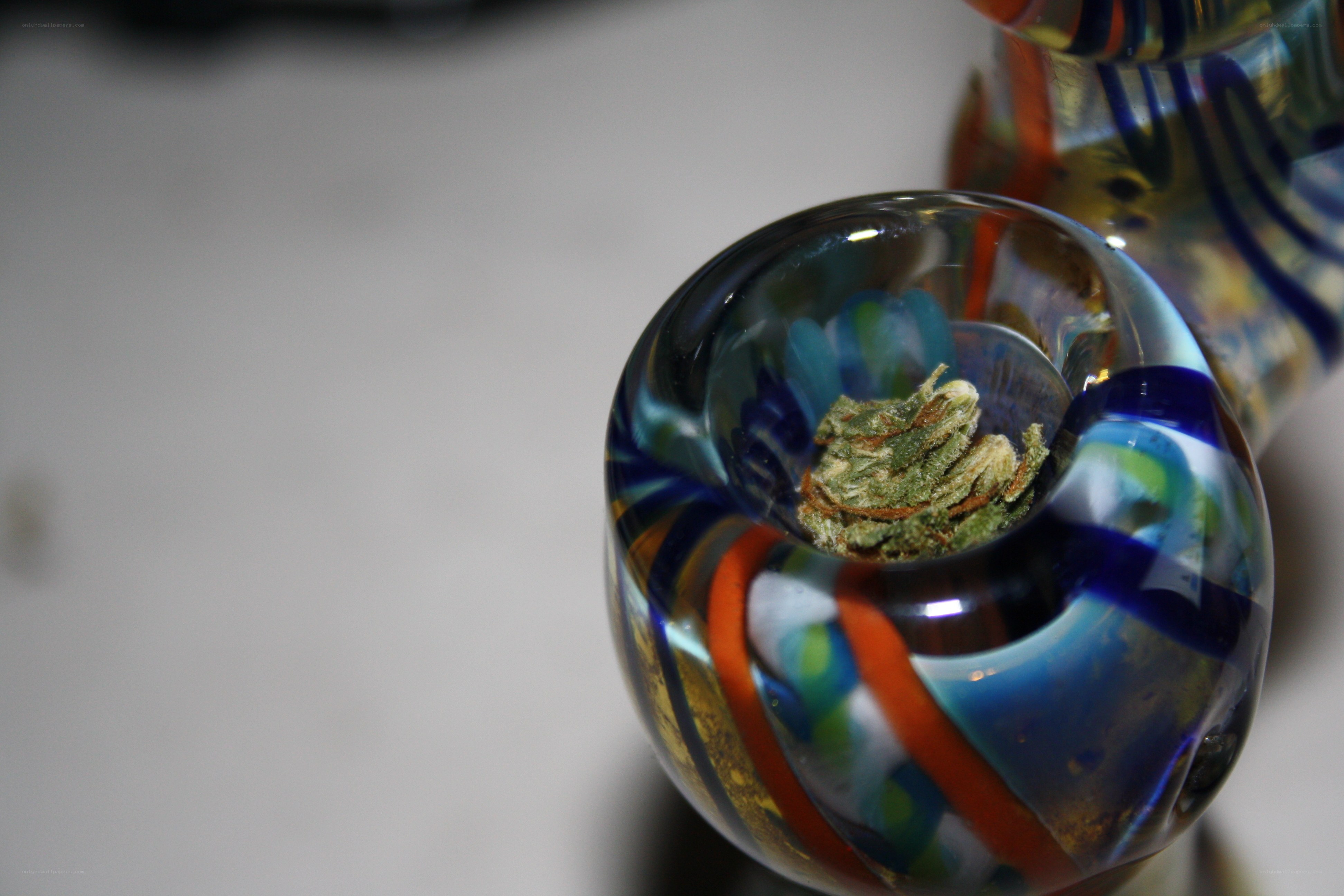Colorful glass pipe with herb