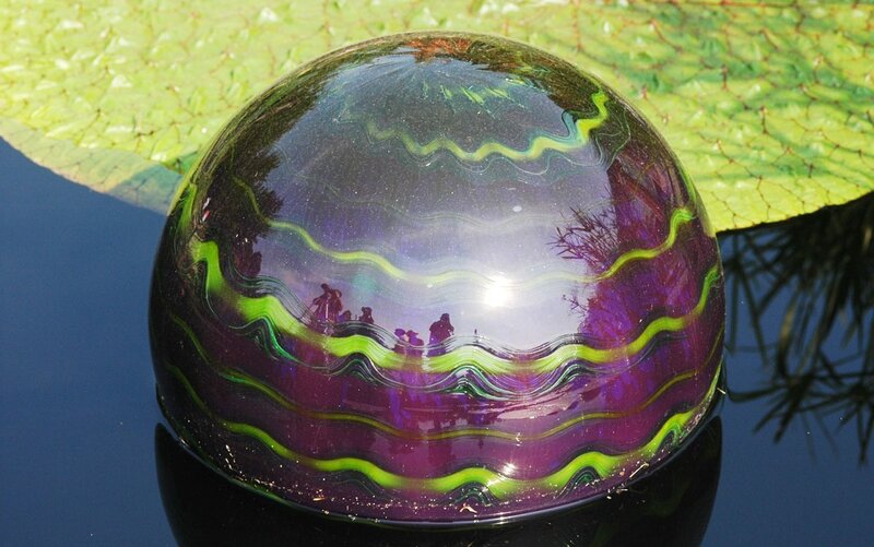 Colorful glass sphere on water