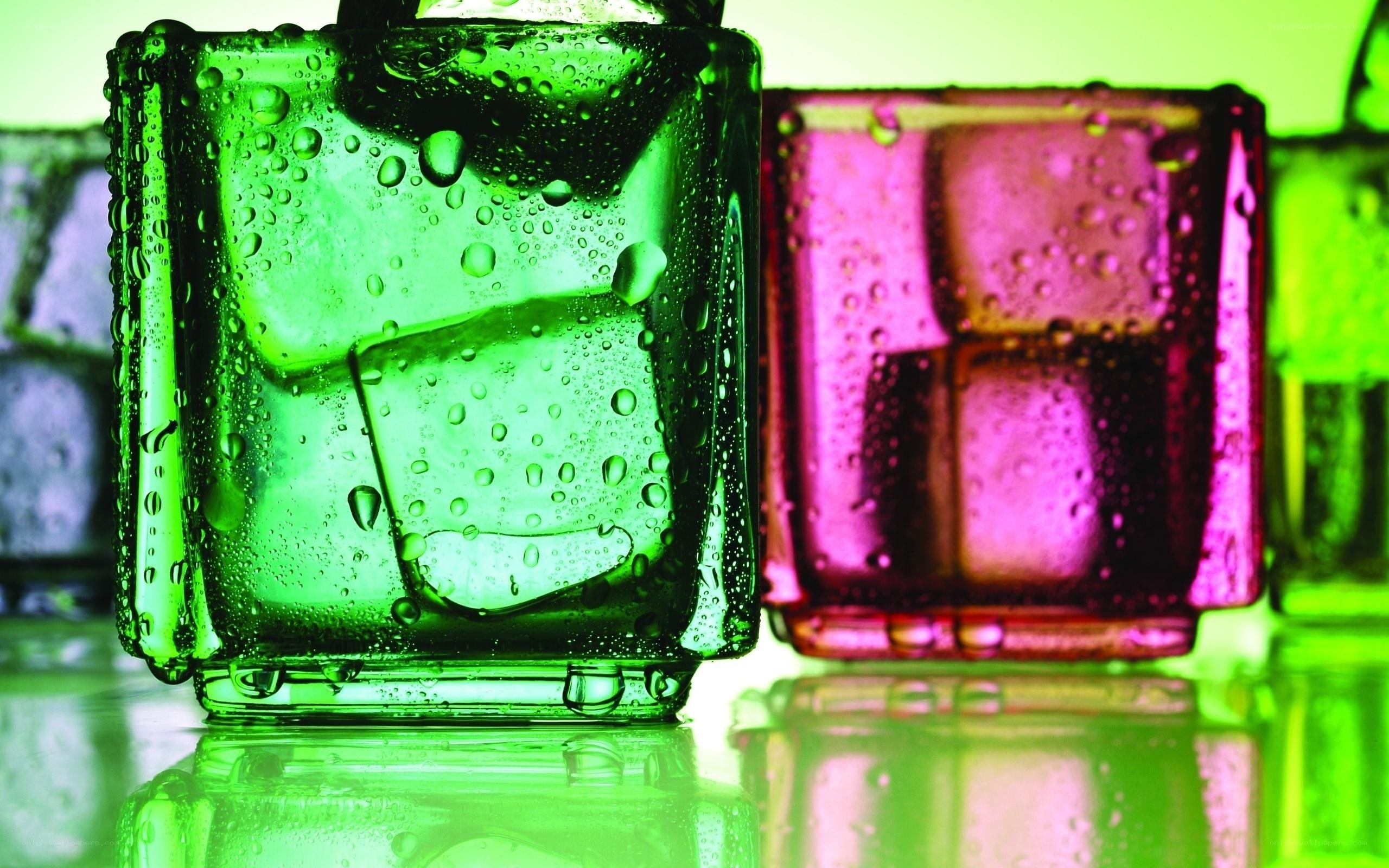 Colorful glasses with ice cubes