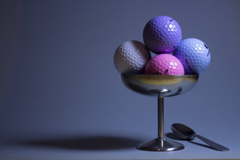 Colorful golf balls in a bowl