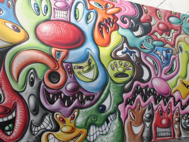 Colorful graffiti mural of cartoon faces