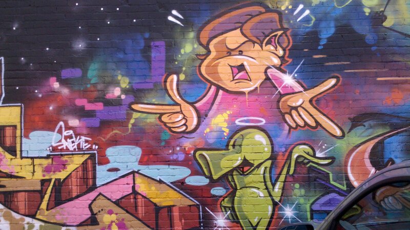 colorful graffiti mural on brick wall
