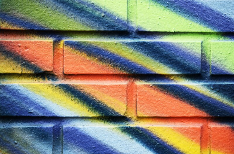 Colorful Graffiti on Brick Wall — Blue, Vibrant