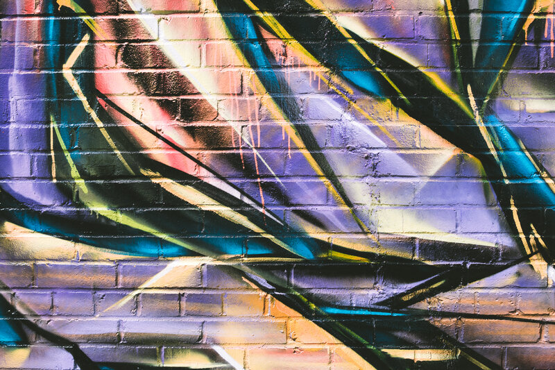 Colorful Graffiti on Brick Wall — Purple, Vibrant