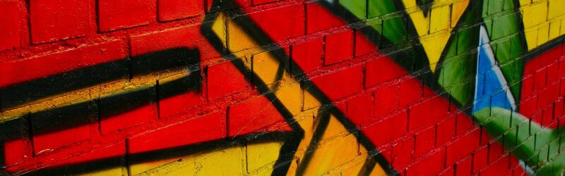 Colorful Graffiti on Brick Wall — Red, Vibrant